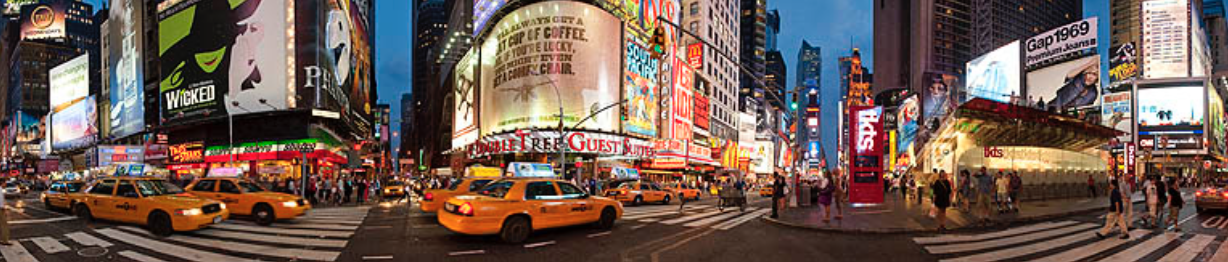 a busy street with multiple cars, pedestrians and billboards