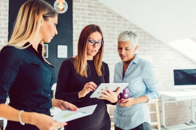 a picture of three women planning an event