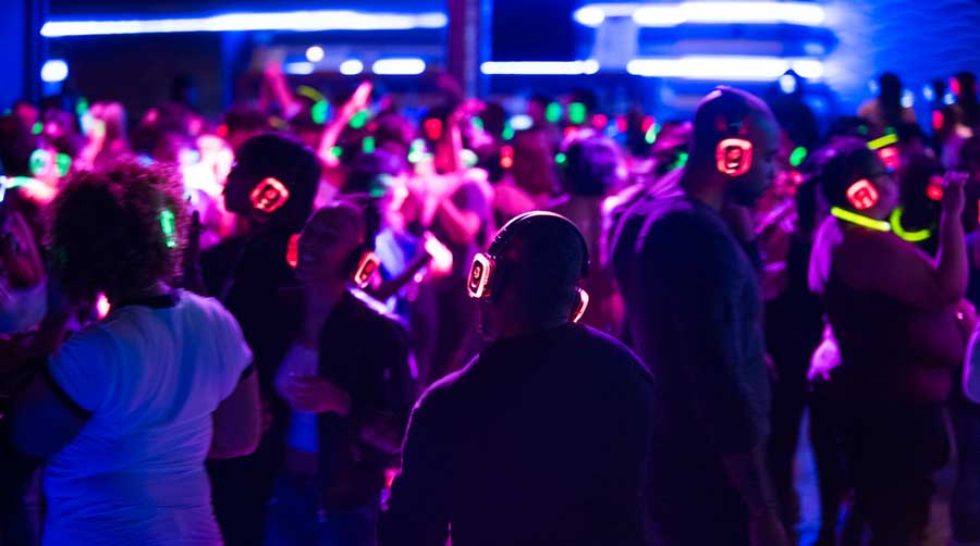 attendees of a silent disco wearing headphones