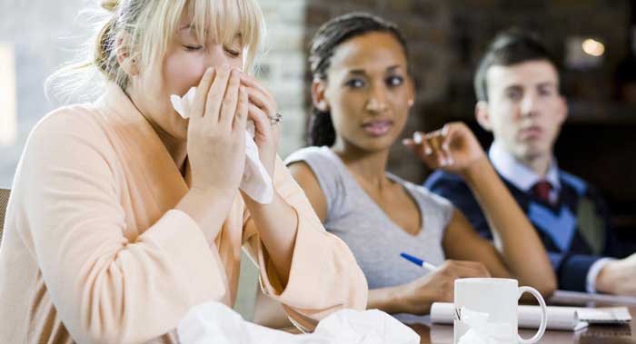 a female employee who is ill at work and her two co-workers are watching her