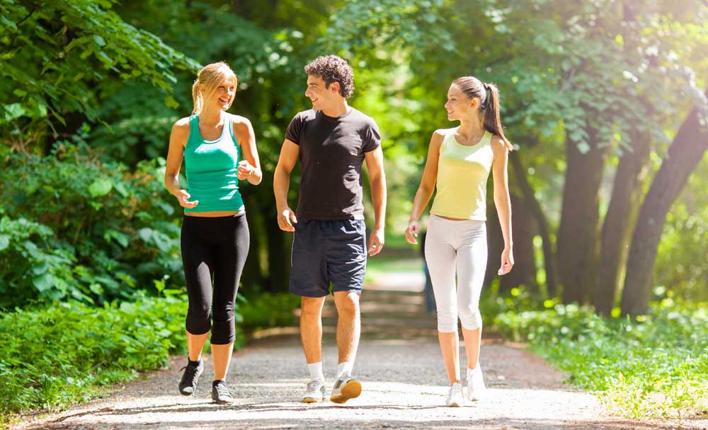 a-group-of-teenagers-walking-and-exercising-outside