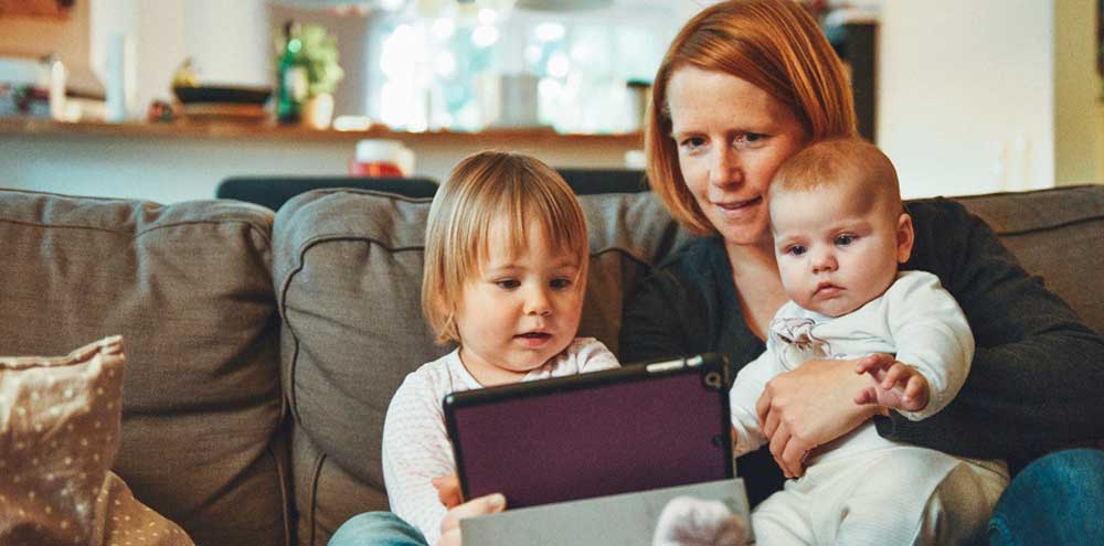 a-mom-and-children-looking-at-an-ipad