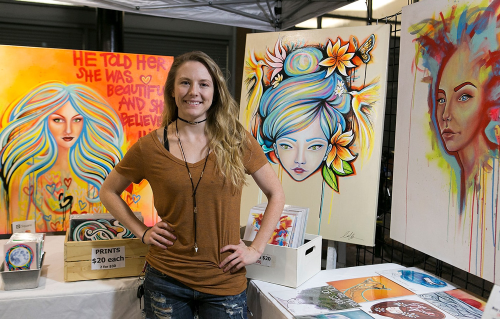 an-arts-vendor-at-a-booth-at-the-fair