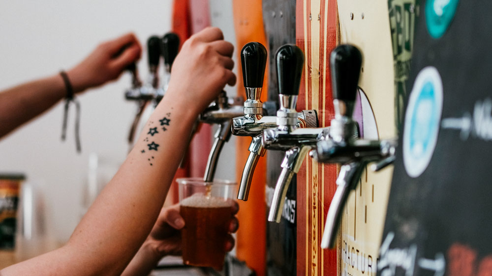 a-woman-pouring-a-beer