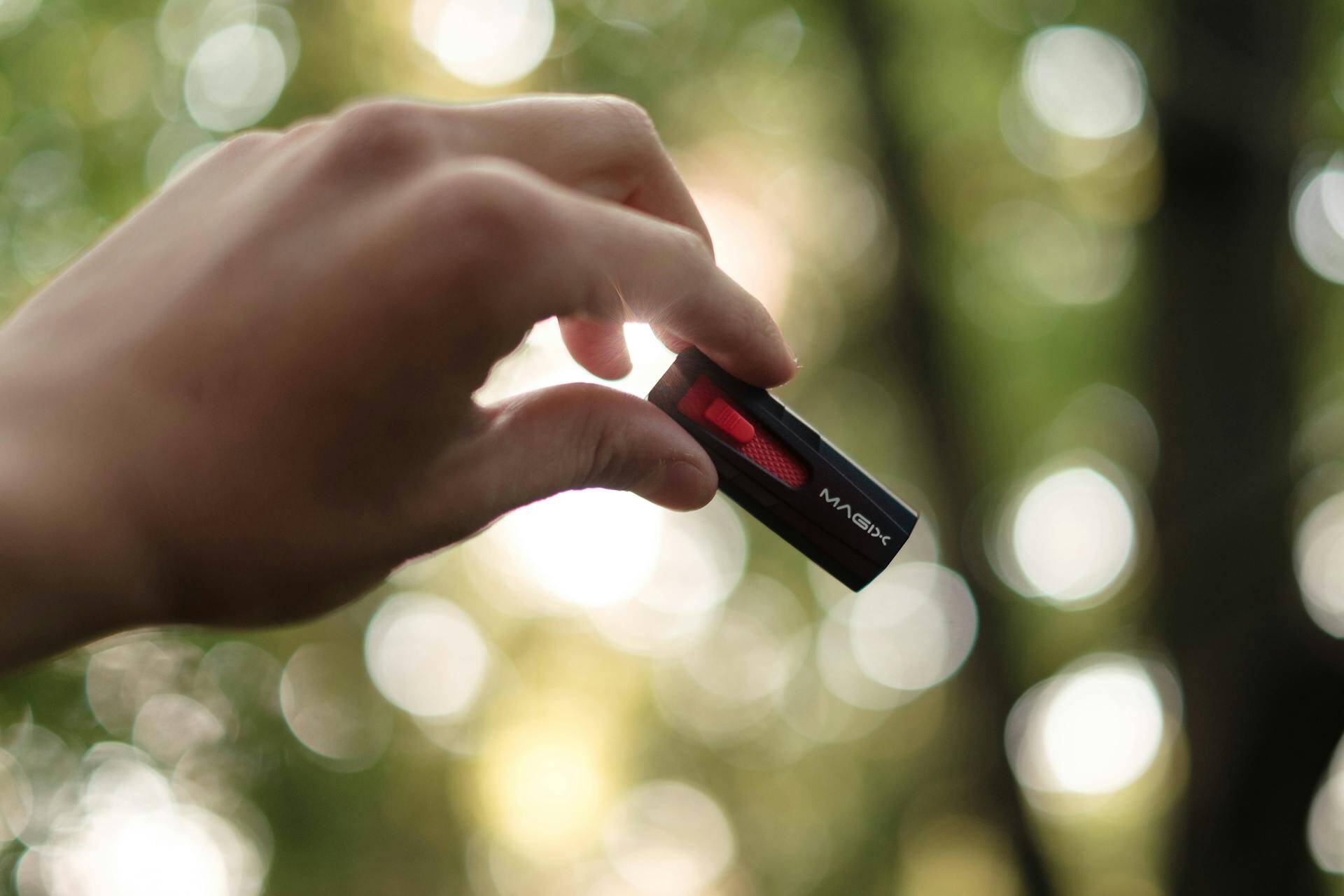 Unrecognizable person showing USB on blurred background
